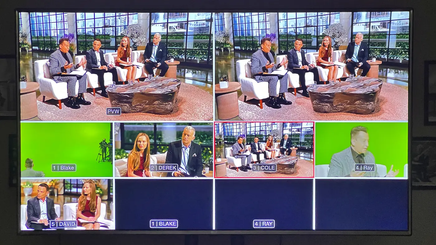 Multiview monitor showing the live chroma key: raw green screen camera feeds on the bottom row and the finished composited program image with a city-view lobby environment on top